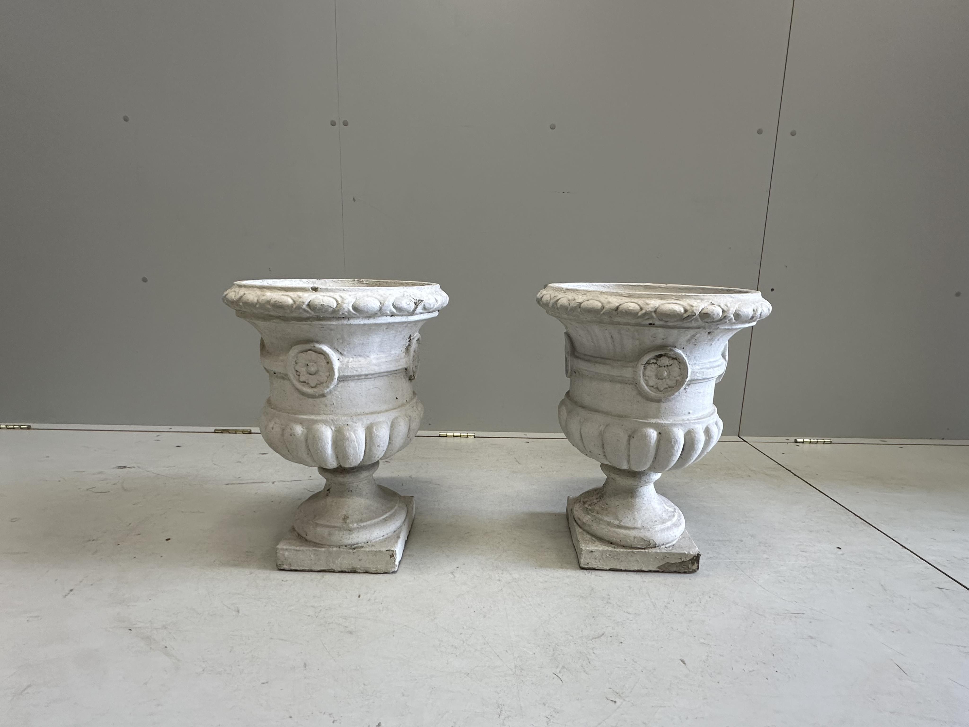 A pair of painted reconstituted stone campana garden urns, diameter 36cm, height 49cm. Condition - poor to fair